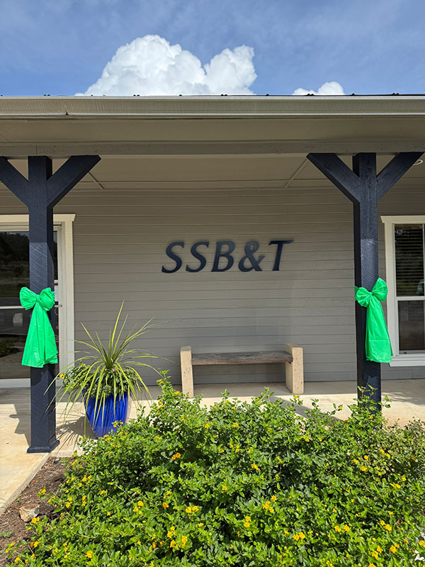 The front of Security State Bank showing green bows on the posts